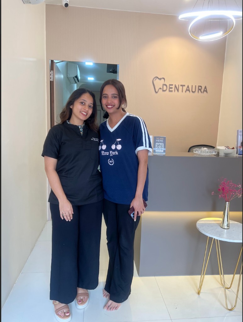 Smiling patients and staff at Dentaura